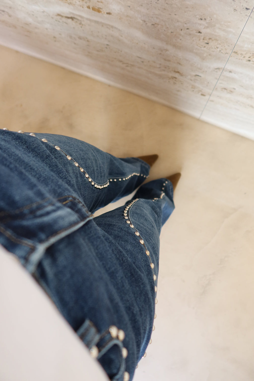 Calça jeans de perna larga com detalhes de tachas
