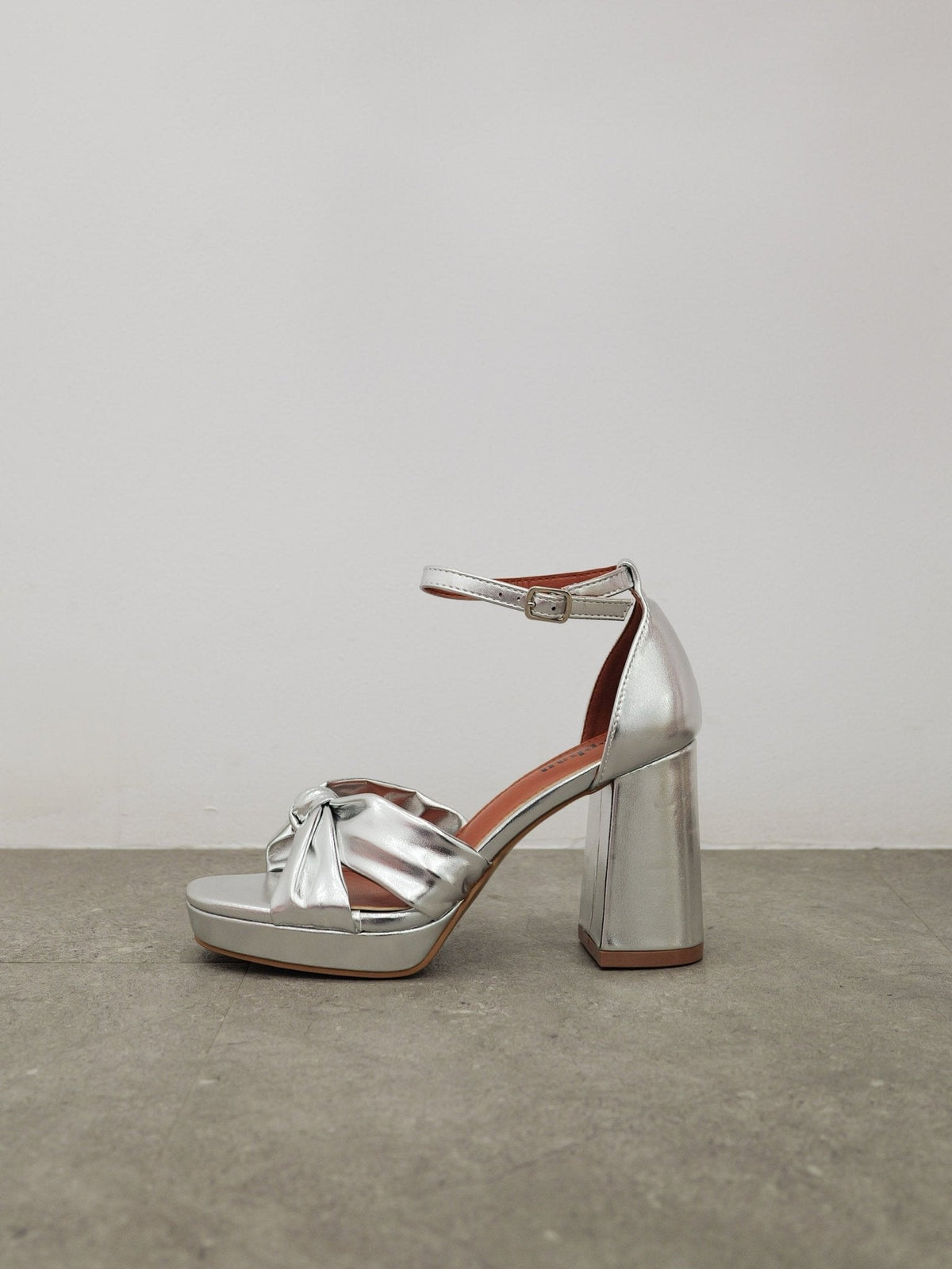 Sapatos de plataforma com laço prateado